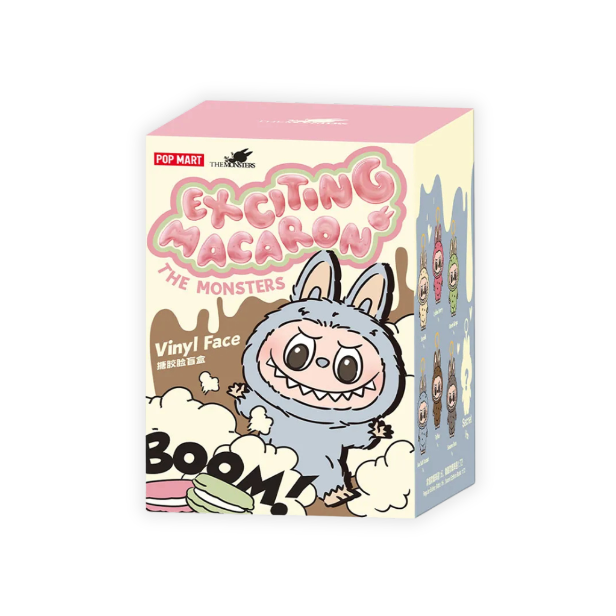 The image shows a Pop Mart The Monsters Exciting Macaron box. The box is predominantly pink and yellow, featuring a cartoonish monster character with bunny ears and a wide smile on the front. The words "Exciting Macaron" are prominently displayed above the monster.