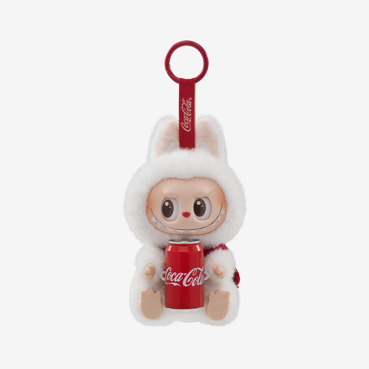 A festive collectible keychain figure from the Pop Mart x Coca-Cola "The Monsters" Vinyl Face series. The character wears a plush white bunny costume with large ears and a cozy red-and-white scarf. It has a cheerful expression with wide eyes and a toothy smile, sitting upright while holding a red Coca-Cola can. The red keychain loop is branded with the Coca-Cola logo, matching the holiday-themed aesthetic.