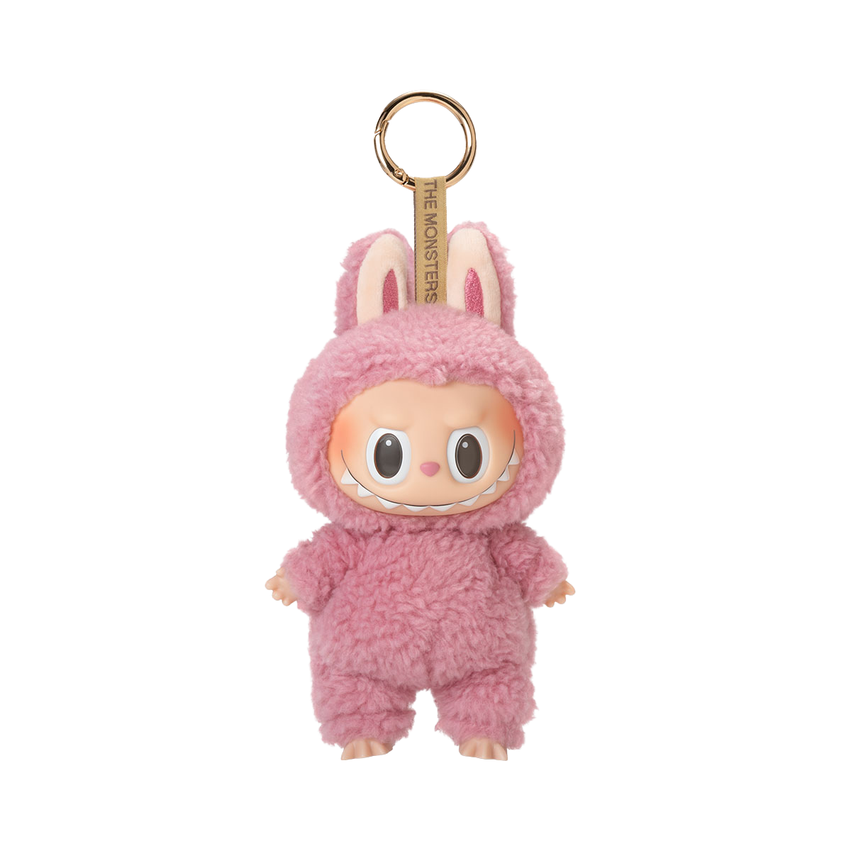 A fluffy pink plush toy keychain of a character with a wide, mischievous smile, large black eyes, and bunny ears, with the text "THE MONSTERS" on the keyring strap.