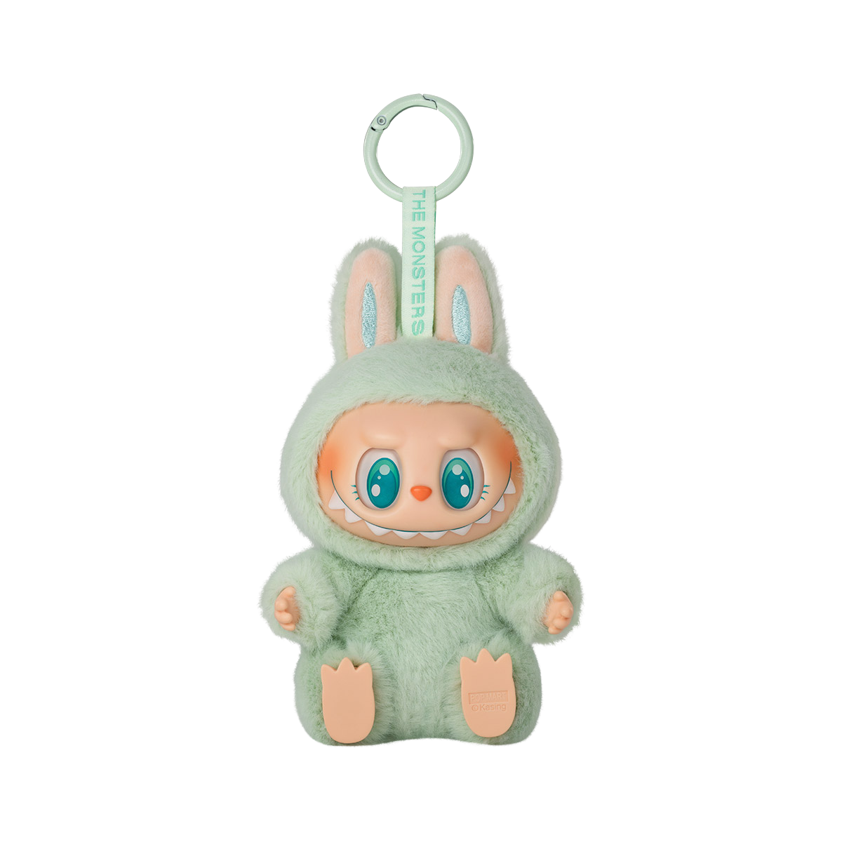 A keychain figure from Pop Mart’s "Have A Seat" Labubu series. The character is dressed in a soft, fluffy pastel green-teal bunny suit with tall ears. It has a mischievous expression with green eyes open in a joyful smile and a wide, toothy grin. The keychain loop is attached to the top, and a tag reading “THE MONSTERS” is printed on the strap. The figure sits with its feet visible and has a plush texture for added charm.