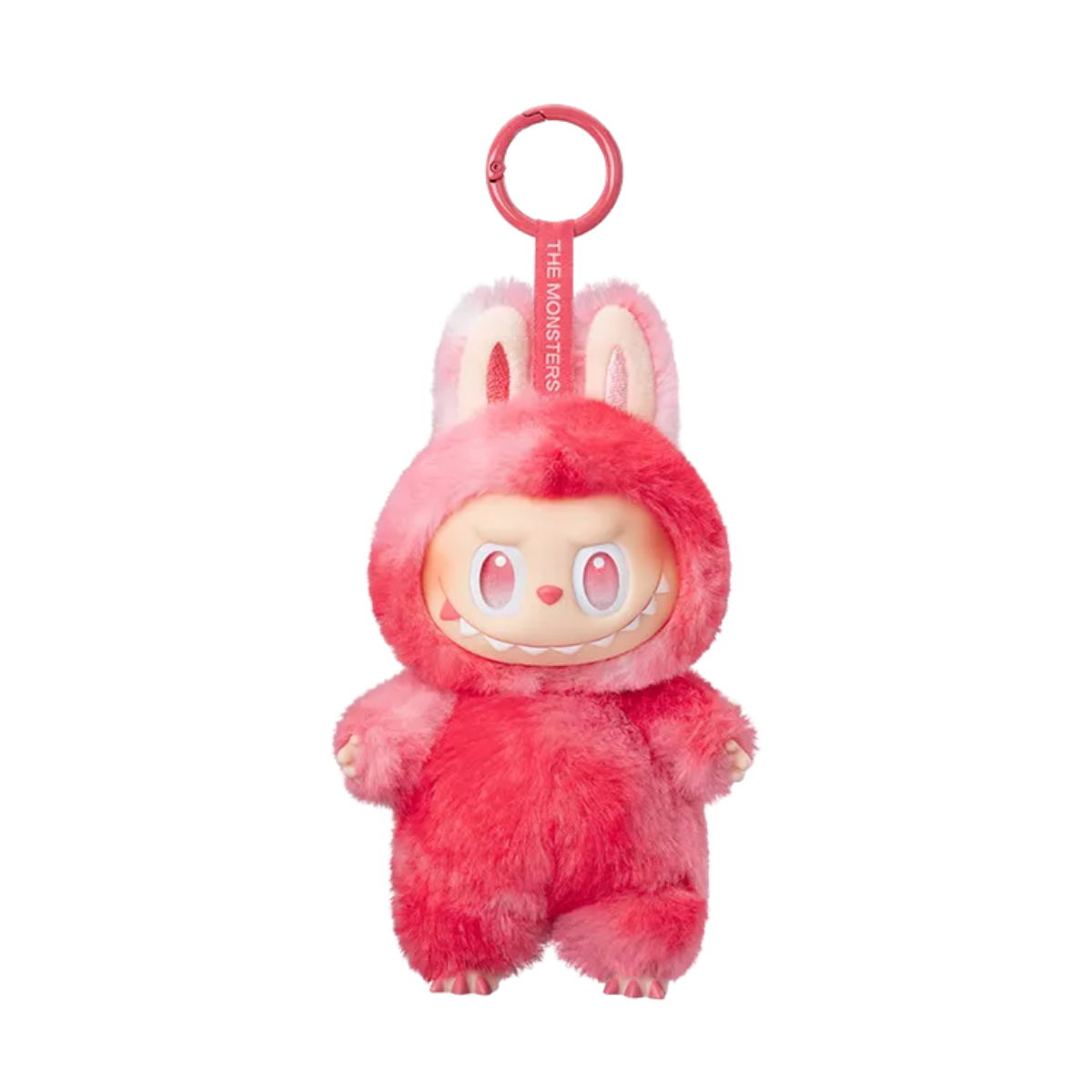 A plush keychain figure from Pop Mart’s “The Monsters” Labubu series. The character is wearing a fuzzy red and pink bunny suit with tall ears and a matching pink keychain strap labeled “THE MONSTERS.” It has striking red eyes and a mischievous toothy grin, giving it an energetic and bold appearance. The plush texture and bright color scheme make this figure both cute and fierce, perfect for collectors who enjoy vibrant and expressive designs.