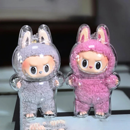 This image shows two Labubu collectible figures dressed in fuzzy bunny suits—one gray and one pink—encased in clear, form-fitting protective shells. The transparent cases are molded to the shape of the standing figures, including the ears and limbs, providing full coverage while allowing the details and colors of the toys to remain visible. The setup appears to be for display or secure storage, combining protection with aesthetic presentation.