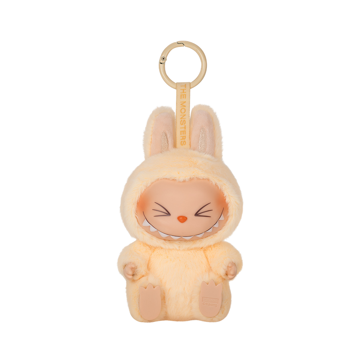 A keychain figure from Pop Mart’s "Have A Seat" Labubu series. The character is dressed in a soft, fluffy pastel yellow bunny suit with tall ears. It has a mischievous expression with eyes closed in a joyful squint and a wide, toothy grin. The keychain loop is attached to the top, and a tag reading “THE MONSTERS” is printed on the strap. The figure sits with its feet visible and has a plush texture for added charm.