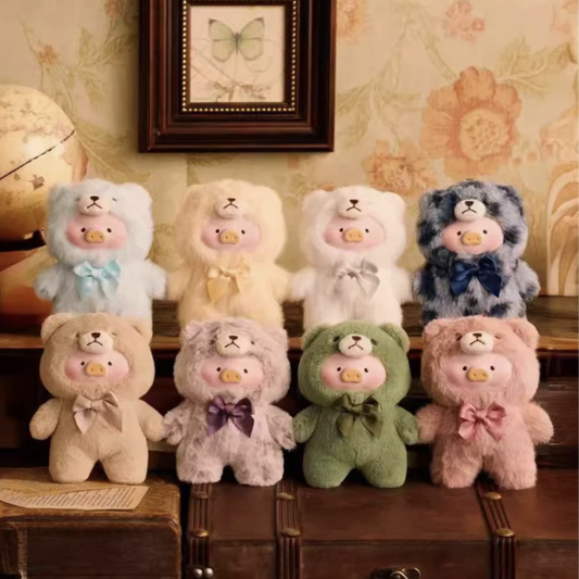 Collection of colorful teddy bears with bow ties on a wooden shelf, featuring the brand 'TOYZERO+'.